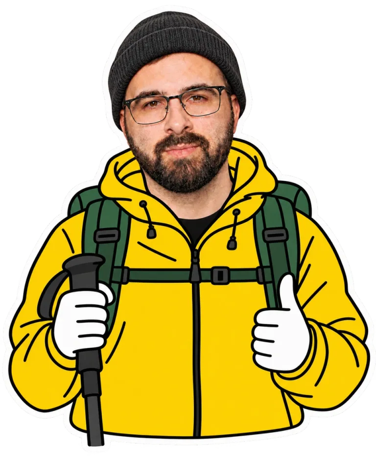 Bradley in yellow hiking kit with backpack, beanie and trekking pole