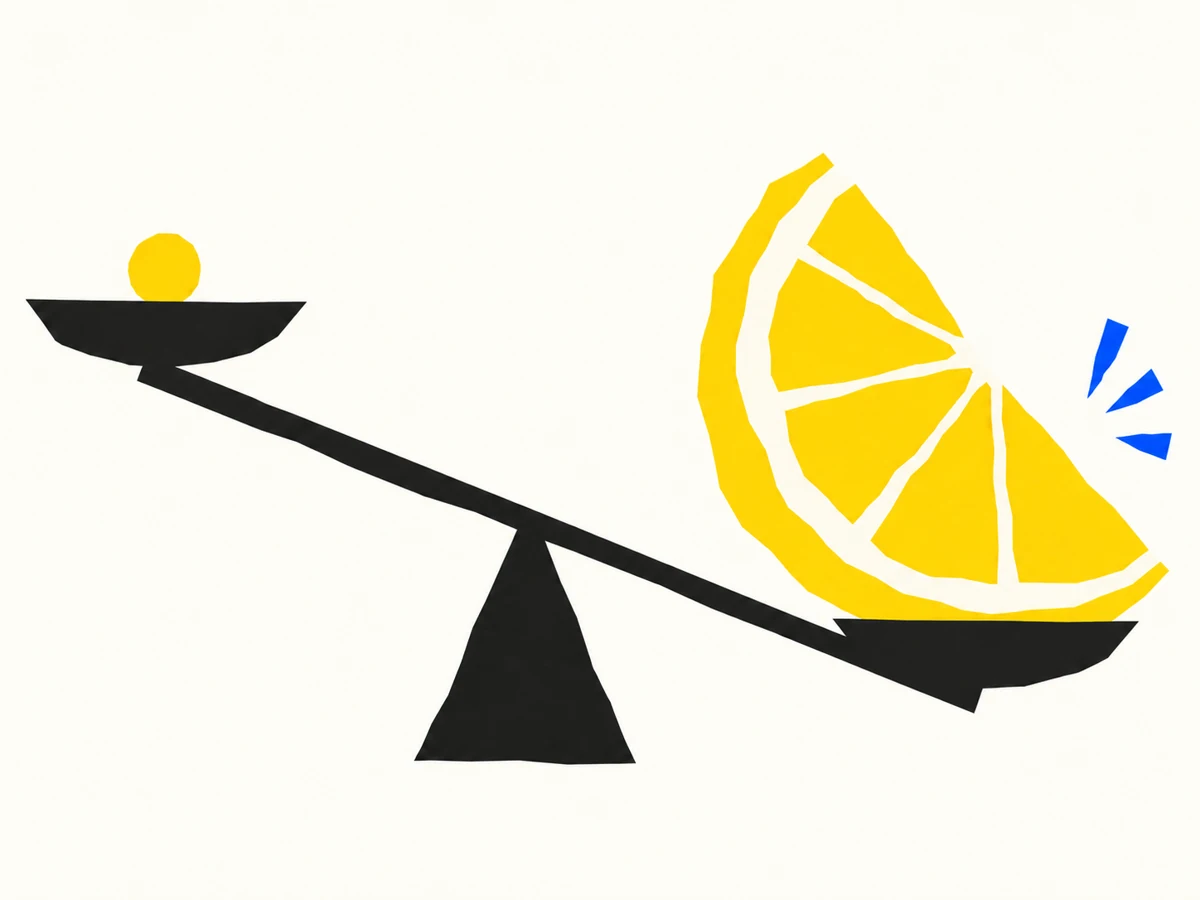 A small yellow coin and a large lemon wedge on an uneven black balance.